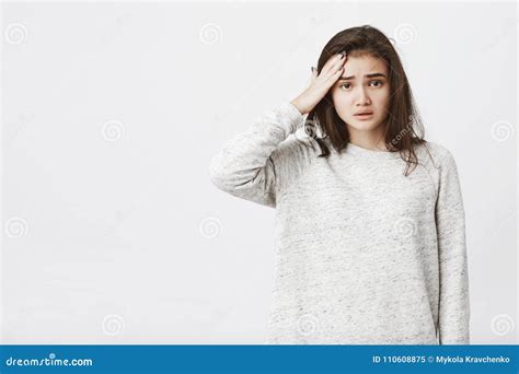 Portrait Of Tired Unhappy European Female Model With Frowned Eyebrows