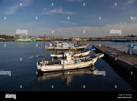 Fishing boats anchored inside Enoshima marina. Enoshima beach is a