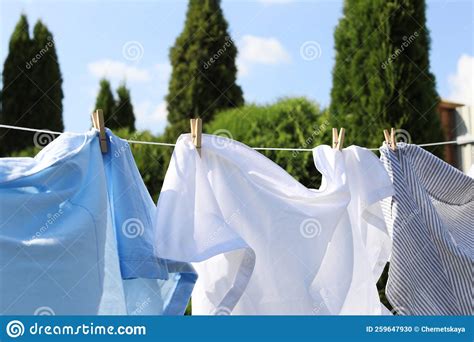 Clean Clothes Hanging On Washing Line Outdoors Closeup Drying Laundry