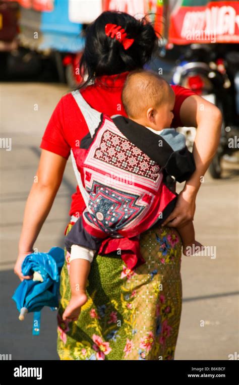 Ethnic Karen Woman From Burma Carrying Her Baby In The Market In Mae