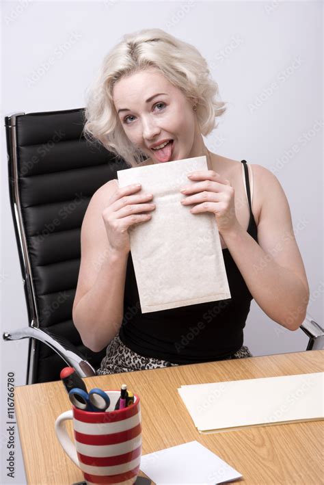 SECRETARY WORKING AT A DESK JULY 2016 Secretary Licking An Envelope