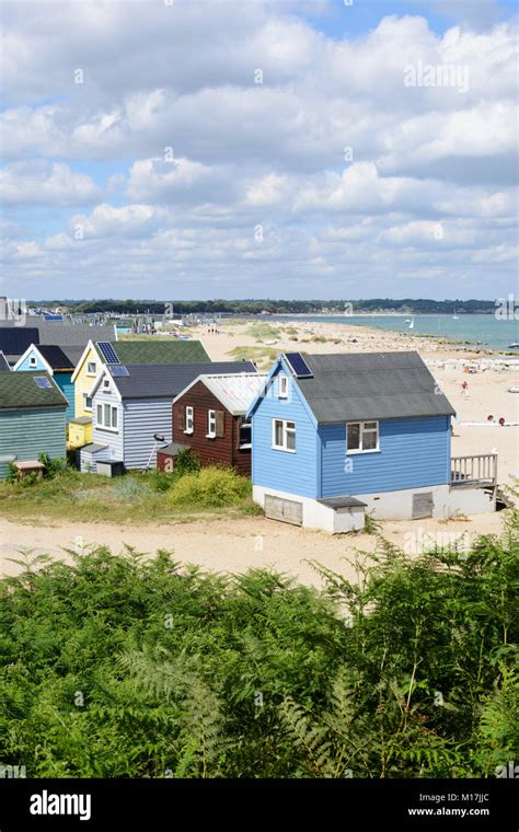 Colourful Painted Wooden Beach Huts Among The Sand Dunes At Mudeford