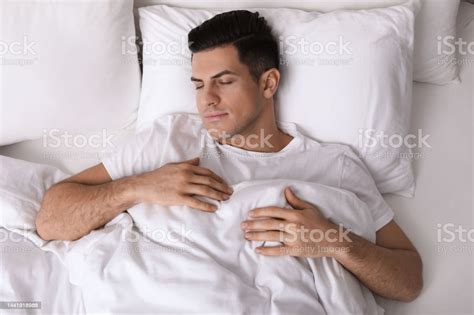 Handsome Man Sleeping In Bed At Home Top View Stock Photo Download