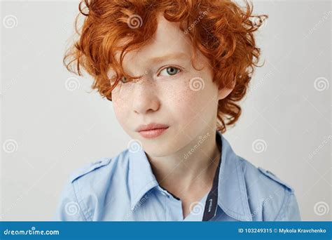 Close Up Portrait Of Beautiful Little Kid With Red Curly Hair And Grey