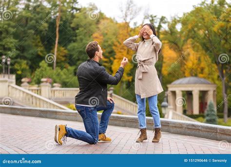 Young Man Proposing To His Beloved In Autumn Park Stock Photo Image