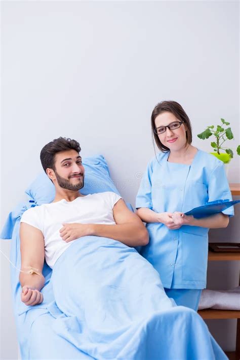 The Woman Doctor Examining Male Patient In Hospital Stock Image Image