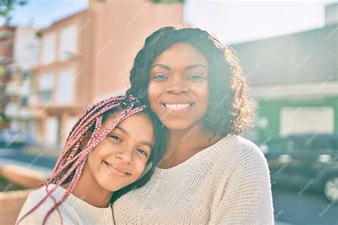 Free Photo Beautiful African American Mother And Daughter Smiling Happy And Hugging Standing