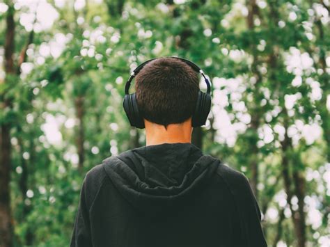 Premium Photo A Man Listening To Music In Headphones Overhead Walking