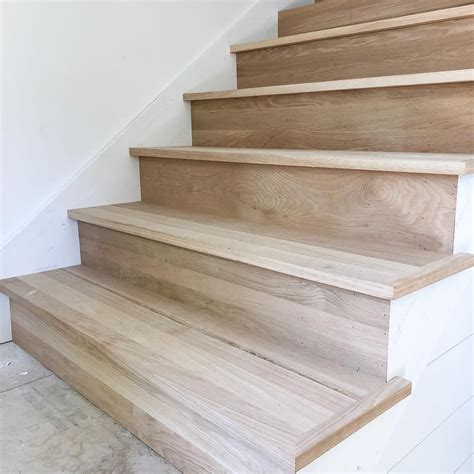Some Wooden Stairs In A House With White Walls