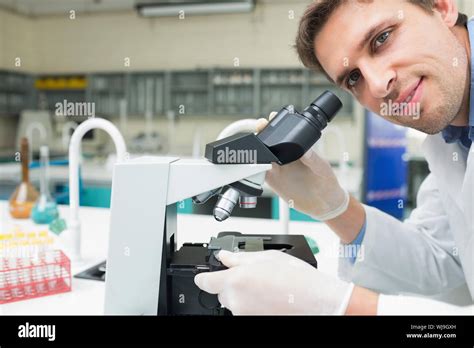 Close Up Portrait Of A Male Scientific Researcher Using Microscope In