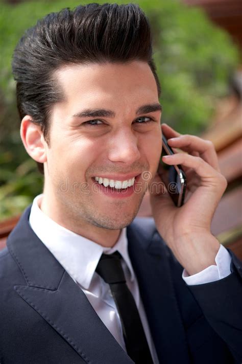 Happy Young Businessman Talking On The Phone Outdoors Stock Image
