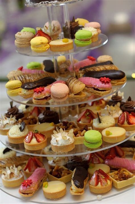 A Three Tiered Tray Filled With Different Types Of Pastries And