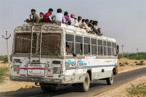 A Bus Full Of People And Passengers Riding On The Roof Jaisalmer