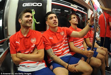 Hector bellerin & lewis hamilton talk tattoos! Arsenal stars ride the subway as they enjoy a spot of ...