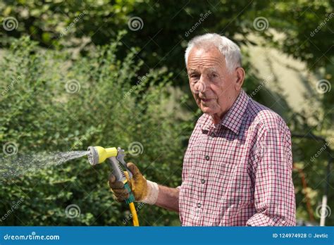 Old Man Watering Plants In Garden Stock Photo Image Of Outside