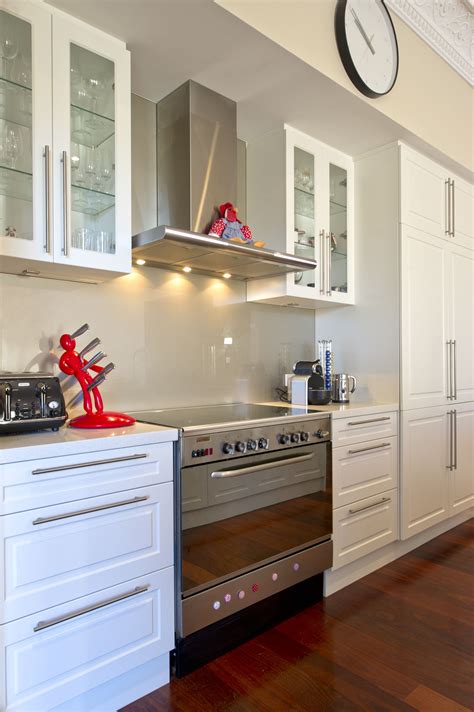 White just shows dirt far too easily. Crisp white kitchen with stainless steel appliances and ...