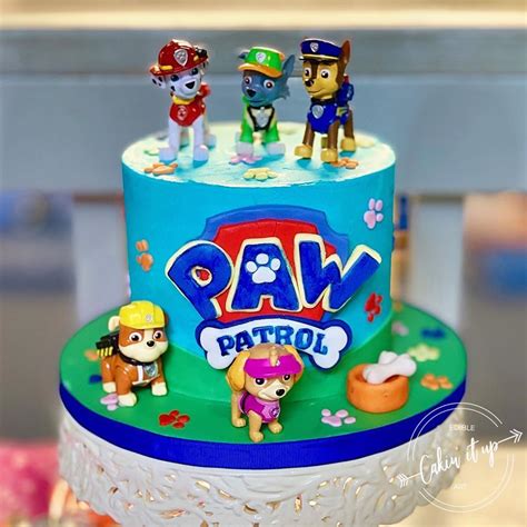 A Birthday Cake With Paw Patrol Figures On Top