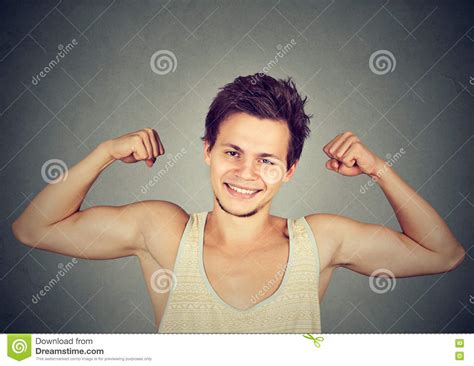 Fit And Muscular Young Man Flexing His Biceps Stock Image