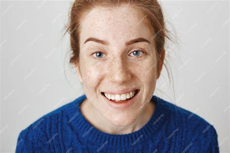 free photo headshot of happy smiling cute redhead girl with freckles
