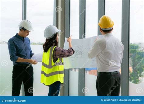 Team Of Engineers Architects Working And Standing Around Table Working