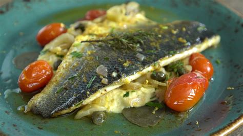 Greek Sea Bass Baked With Santorini Assyrtico Wine Capers Leaves And Herbs Diane Kochilas