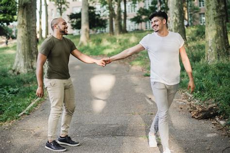 Two Men Holding Hands And Walking Together · Free Stock Photo