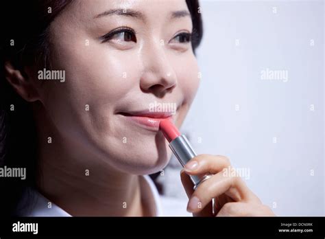 Close Up Shot Of A Woman Putting Lipstick On Stock Photo Alamy