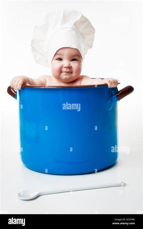 Little Child Wearing Chefs Hat In A Cooking Pot Stock Photo Alamy