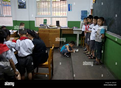 Teacher Makes 4 Pupils Stand In Front Of The Blackboard In The Class