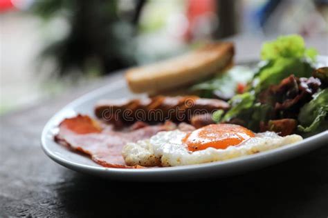 English Breakfast Fried Egg Hamsausage Baconsalad And Toast Stock