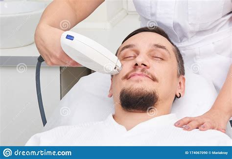 Man Having Laser Treatment At Beauty Clinic Stock Photo Image Of Care