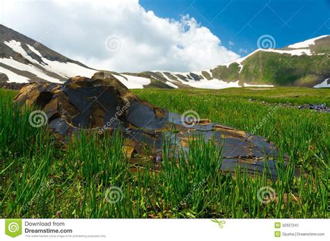 Mountains Covered With Snow Big Stone And Meadow Stock Image Image
