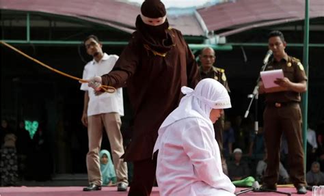 indonesia aceh whips two men woman for breaking sharia law