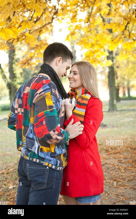 Young Romantic Couple Kissing Under Tree In Autumn Park Stock Photo Alamy