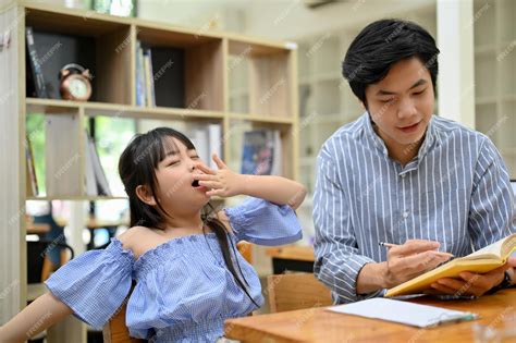 Premium Photo Pretty Asian Girl Yawning While Her Private Tutor