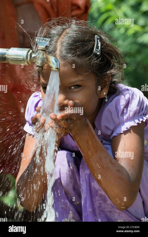 Ethnic Child Drinking Water From Tap Hi Res Stock Photography And