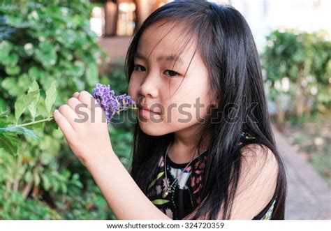Cute Little Girl Smelling Flower Stock Photo 324720359 Shutterstock