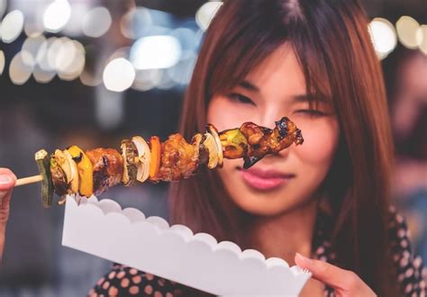 Premium Photo Hungry Woman Is Smiling While Receiving Bbq Skewer And