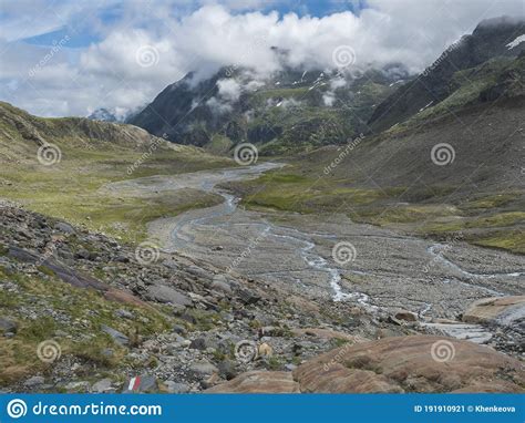Summer View Of Alpine Mountain Valley With Winding Stream And Glacial