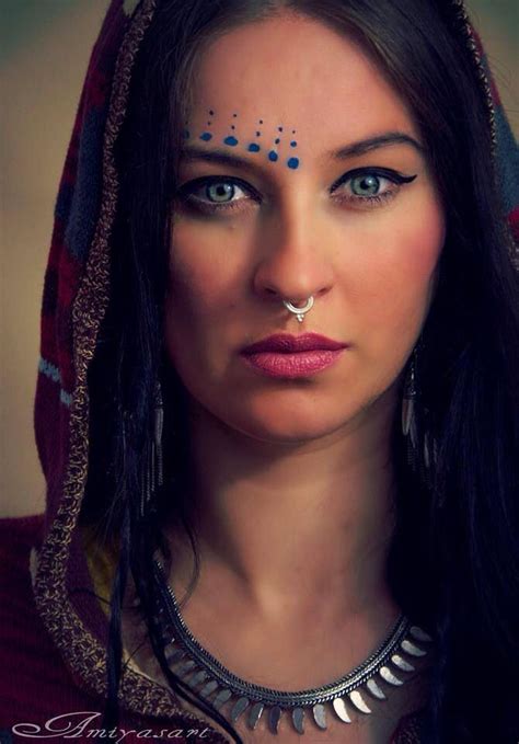 A Woman With Blue Eyes And Nose Piercings