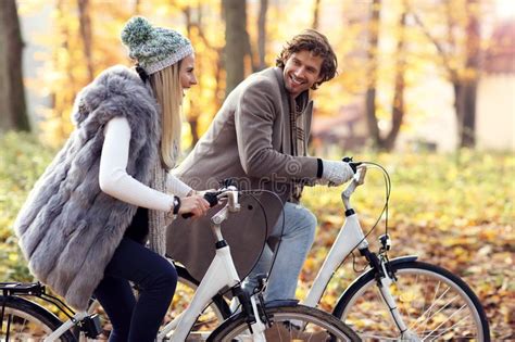 Happy Couple On Bikes In Forest During Fall Time Stock Photo Image Of