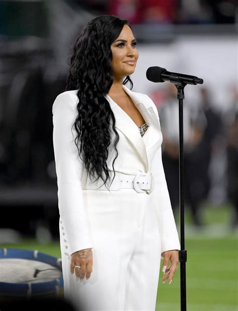 Demi Lovatos White Sergio Hudson Jumpsuit At The Super Bowl Popsugar