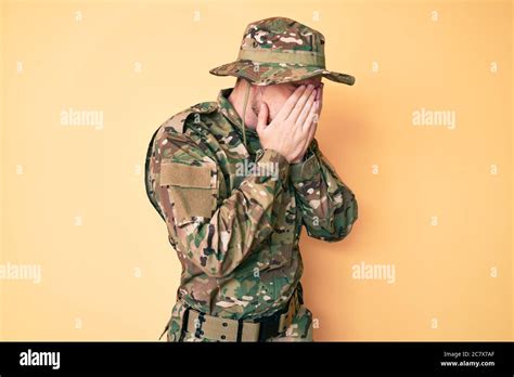 Young Caucasian Man Wearing Camouflage Army Uniform With Sad Expression