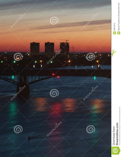 Night Cityscape With River Bridges And Reflections In Water Stock Photo