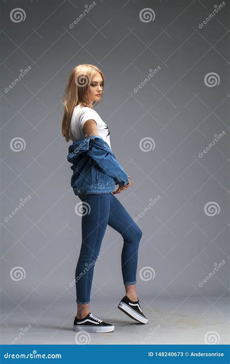Beautiful Blonde Woman Dressed In A Denim Jacket And Blue Jeans Stock Image Image Of Isolated