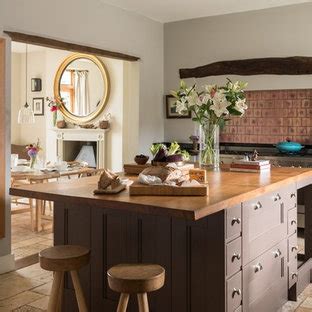 This kitchen was designed to accommodate an enthusiastic cook and entertainer who wanted a contemporary feel that would not be at odds crisp white cabinets brighten dark brown subway tile walls in this transitional kitchen. 75 Most Popular Farmhouse Kitchen with Brown Cabinets ...