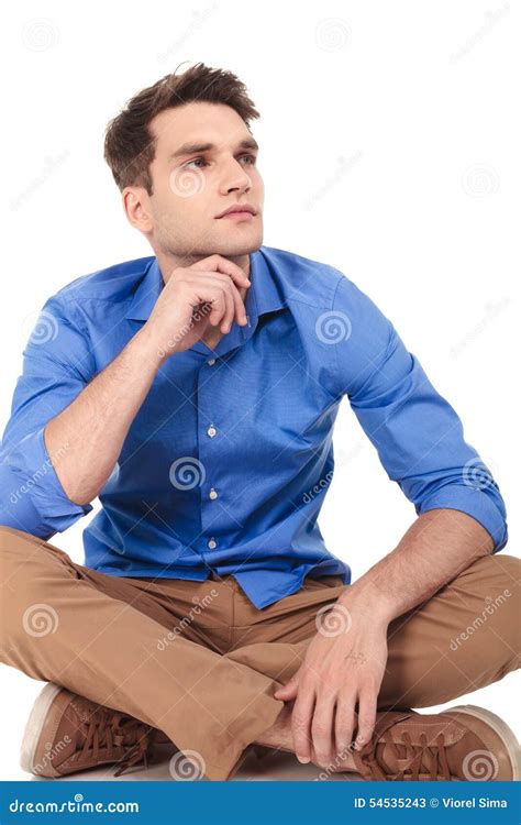 Pensive Young Man Sitting With His Legs Crossed Stock Image Image Of