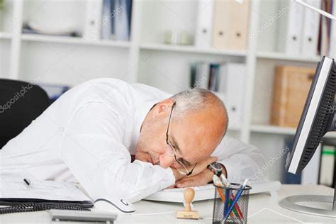 Mature Businessman Sleeping On Desk — Stock Photo © Racorn 25825393