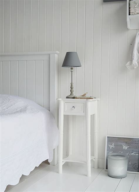 Tall nightstands can be a perfect fit for popular tall beds. New England white beside table with silver handle. A tall narrow nightstand … | White bedside ...