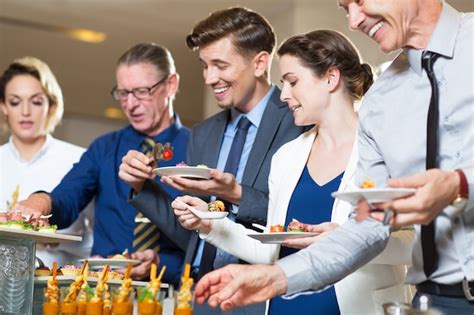 Happy Business People Serving Themselves In Buffet Photo Free Download